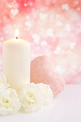 Valentine's hearts and candle with a bright background
