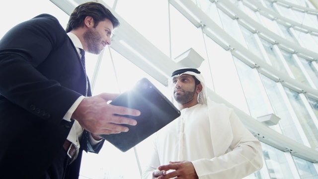 handshake Middle Eastern American business male tablet real estate development