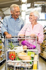 Happy senior couple shopping together 