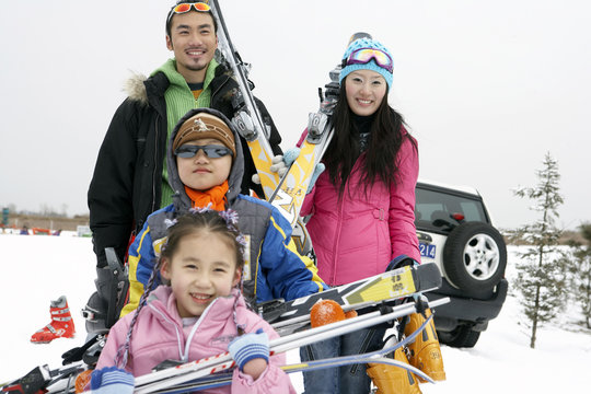 Young Family Preparing For A Day Skiing