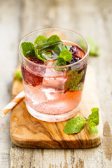 Cocktail with blackberry and fresh mint