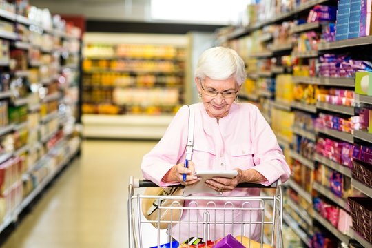 Senior woman looking at her grocery list 