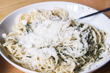 Pasta with pesto sauce and lots of parmesan cheese