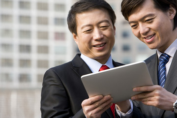 Business partners using a tablet together