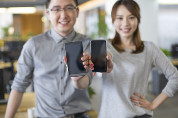 IT workers showing smart phone in office