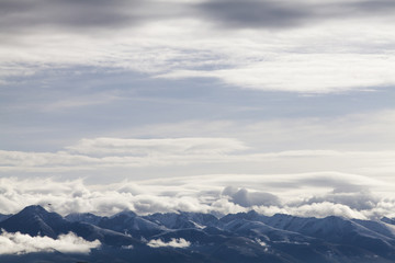 Fototapeta na wymiar Snow mountains and cloudy sky in Tibet, China