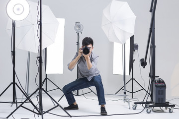Photographer taking picture in studio