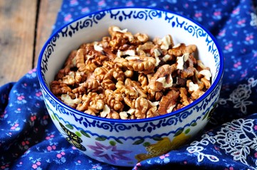 Walnuts in a bowl on a wooden table