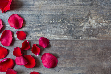 Red petals on wood