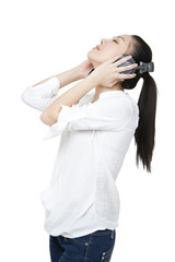 Young woman relaxing by listening to headphones