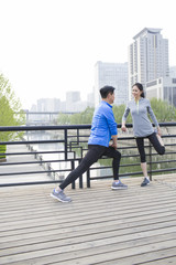 Happy mature couple exercising in park