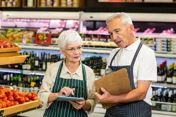 Senior colleagues with clipboard working 