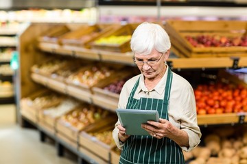 Senior employee working with tablet 