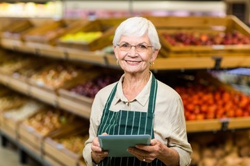 Senior employee working with tablet 