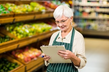 Smiling senior worker with clipboard 