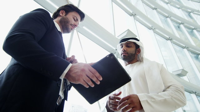 Middle Eastern male American business tablet technology stocks shares trading 