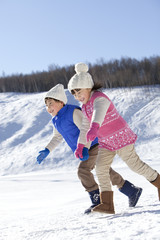 Fototapeta na wymiar Children having fun in snow