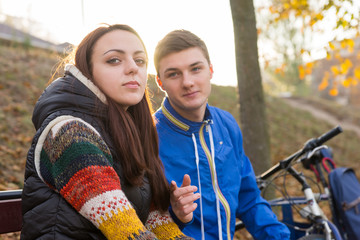 Young Couple Sitting Together on Park Bench