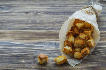 Croutons of white bread  in paper bag.