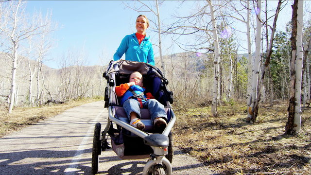 outdoor lifestyle Caucasian USA mother child family walking buggy togetherness 