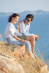 portrait of asian younger man and woman relaxing vacation at sea