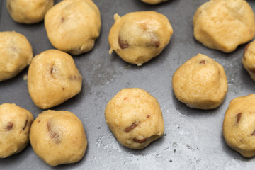raw chocolate cookie dough on tin baking tray, selective focus