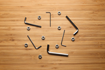 hex keys and nut on a wooden background