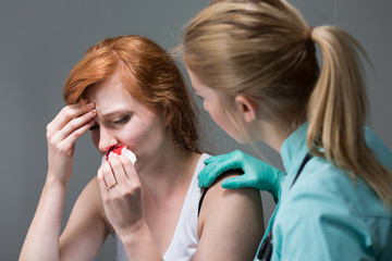 Young woman with nosebleed