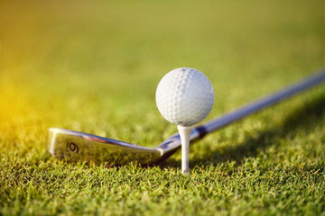 golf ball on tee with club