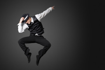 Young male professional dancer dancing in studio. - obrazy, fototapety, plakaty