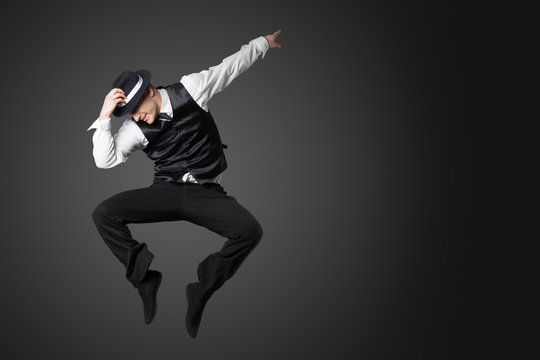 Young male professional dancer dancing in studio.