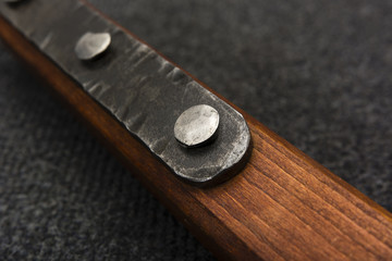 wooden handle with metal reinforcement and iron rivets - blacksmith work