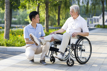 Wheelchair bound man with nursing assistant