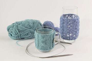 Knitted coats for mugs and glasses with clews