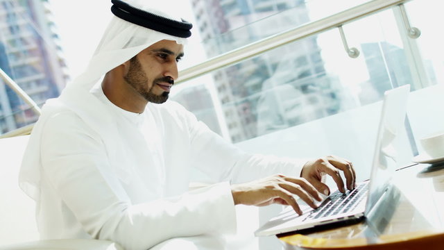 Arab businessman kandura oil trade consultant city wireless laptop technology