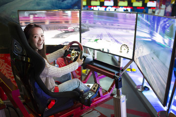 Young woman playing at video arcade
