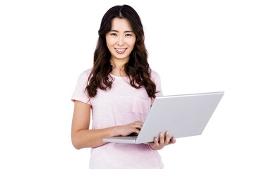 Portrait of happy woman holding laptop