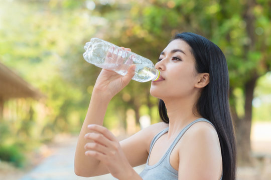 Woman drinking water from Bottle