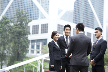 Cheerful business persons discussing with each other in Hong Kong