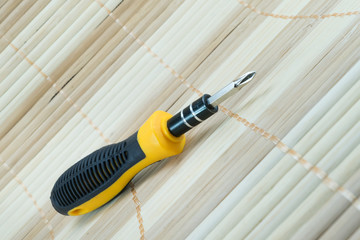 screw driver on bamboo matting - 99541748
