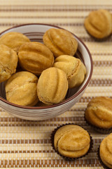 Fototapeta premium Walnut shaped cookies with caramel and walnuts - Russian Oreshki. Selective focus.