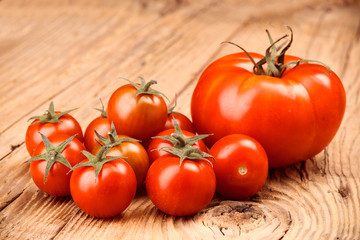 whole and crushed tomatoes on wooden board