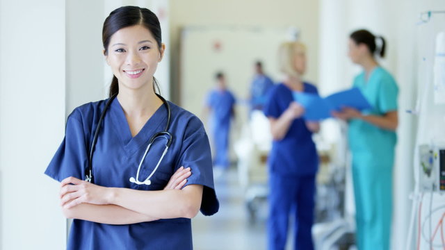 Portrait of professional Asian American female hospital staff wearing scrubs