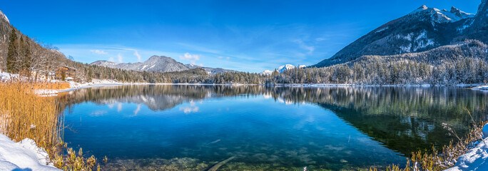 Idyllic winter wonderland with mountain lake in the Alps