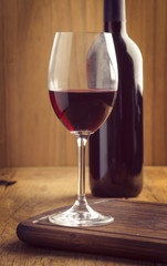 glasses and bottle of wine on old wood