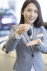 Saleswoman showing car key
