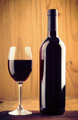 glasses and bottle of wine on old wood