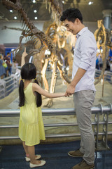 Fototapeta na wymiar Young father and daughter in museum of natural history
