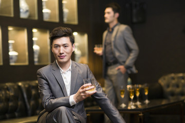 Business partners drinking alcohol in luxury club