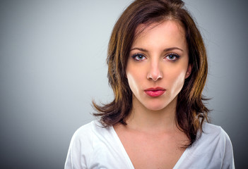 Naklejka premium Serious attractive young woman pouting her lips
